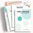 flatlay printable habit tracker journal workbook PDF pages on top of ring binder and notebook