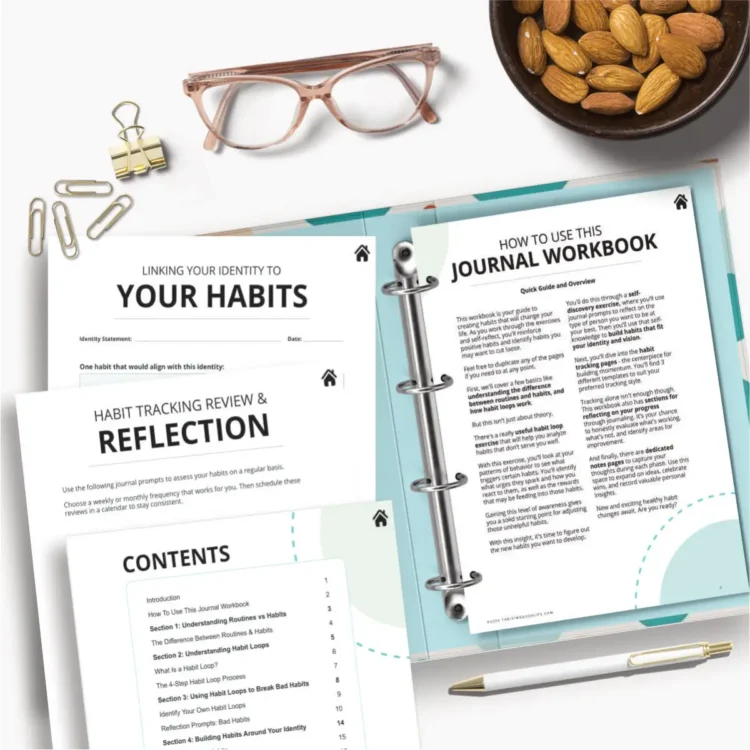 flatlay printable habit tracker journal workbook PDF pages on top of open ring binder