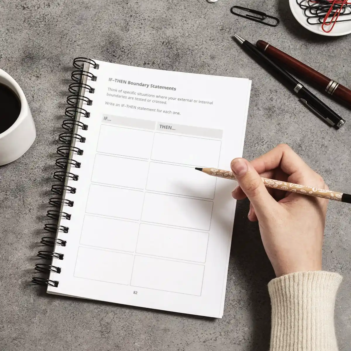 Person writing in the Practice Builds Boundaries journal, showing the interior pages for setting and reinforcing boundaries.