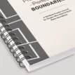 Close-up of the spiral binding and modern cover design of the Practice Builds Boundaries self-management journal.